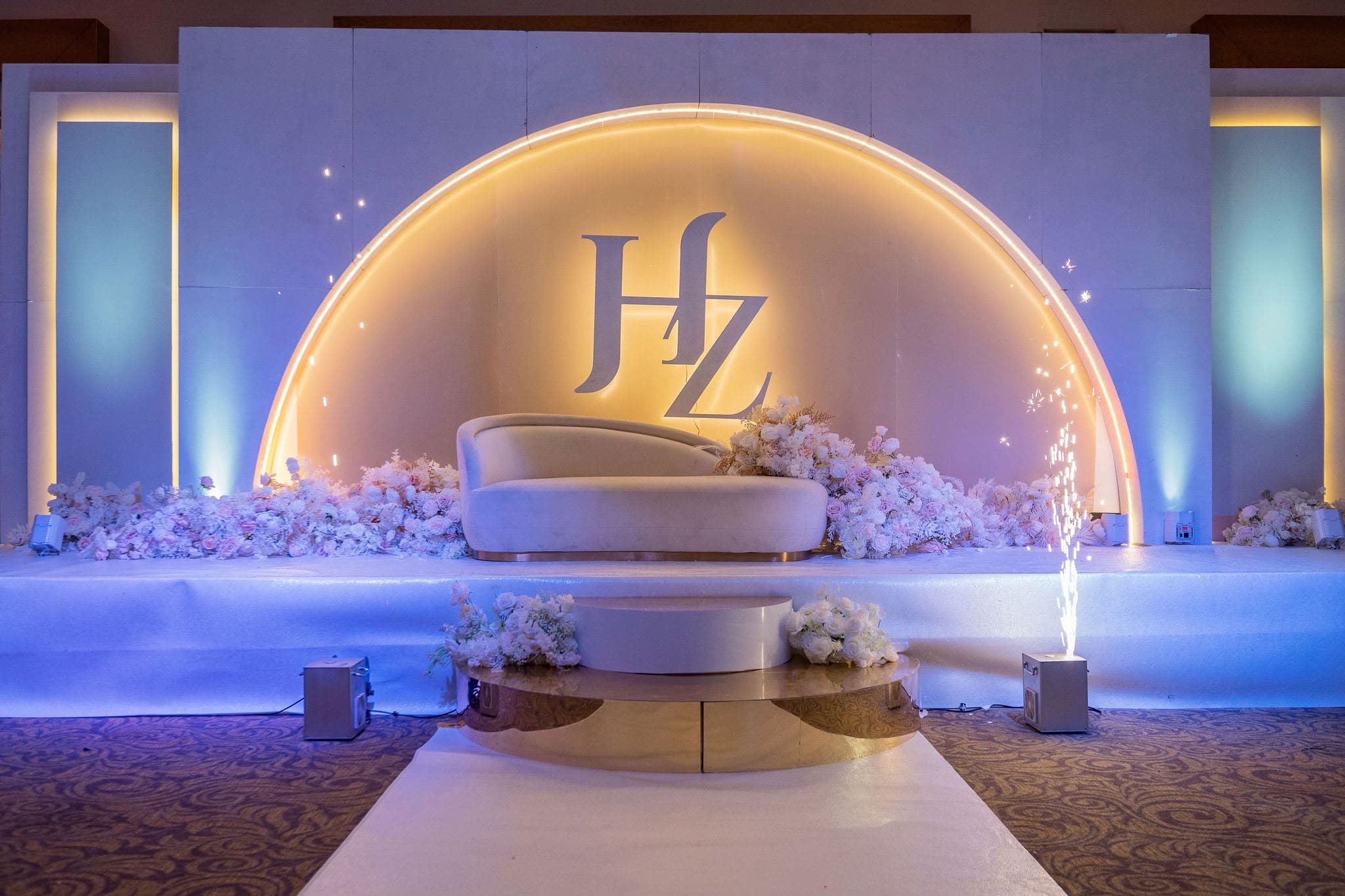 Illuminated circular wedding backdrop in gold with violet lighting
