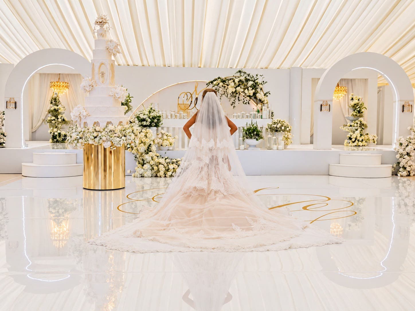 Bride at a white and gold wedding ceremony