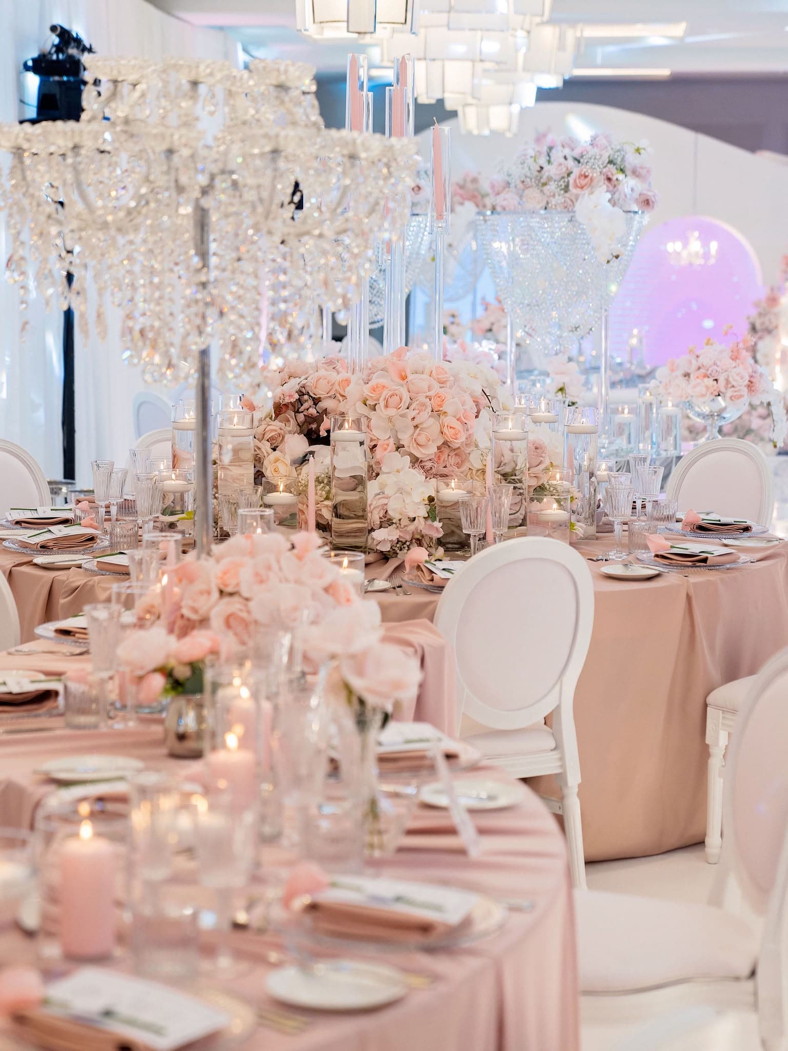 Blush pink chairs and a carefully dressed celebration table